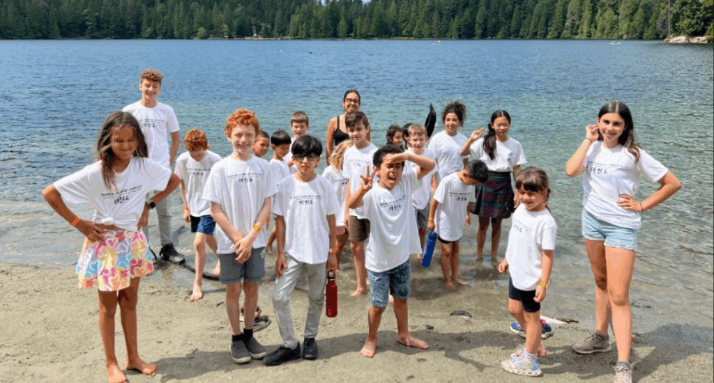 Group of kids standing at the edge of a lake during Endurance Taekwondo’s summer camp
