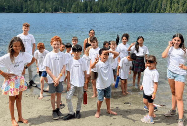 Group of kids standing at the edge of a lake during Endurance Taekwondo’s summer camp