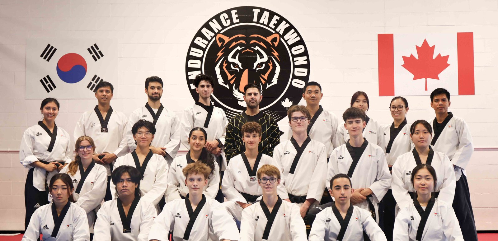 The Endurance Taekwondo instructor team together in uniform at a staff workshop in Port Moody