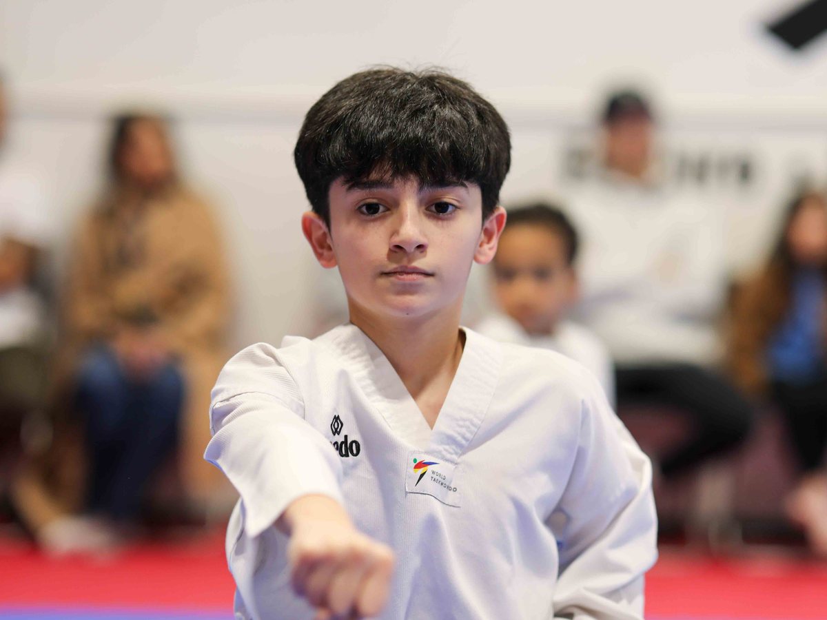 Young student throwing a middle punch, eyes forward